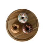 A variety of donuts- 3 pictured. The top is vanilla with sprinkles, left is maple, and the right is chocolate with sprinkles.